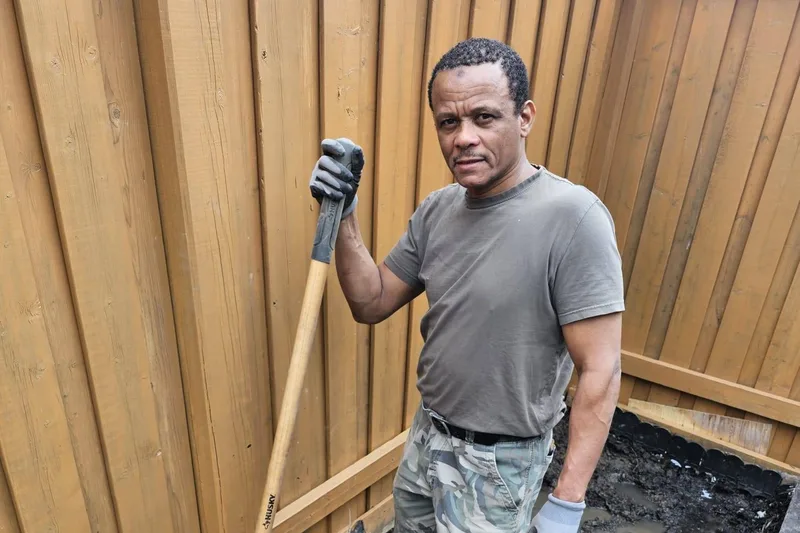 A man digging soil in a garden