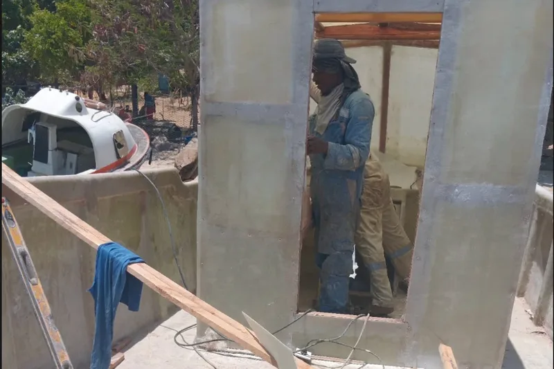 Workers building a fibreglass boat cabin