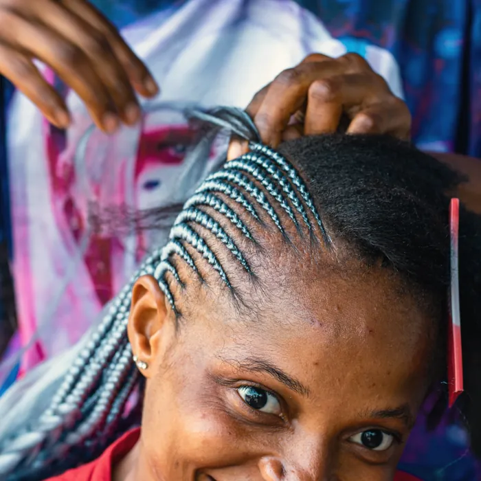 Hair being braided in a salon