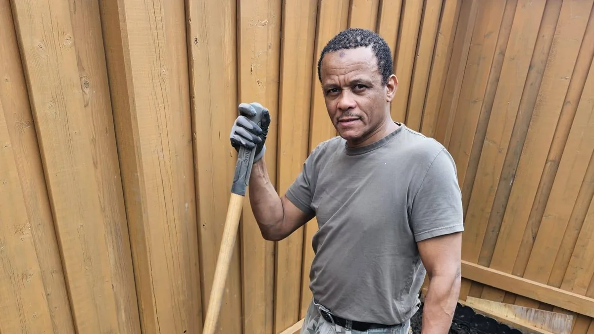 A man digging soil in a garden